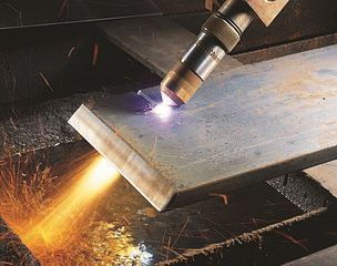 CNC Plasma Torch in Action Cutting through a Steel Shee